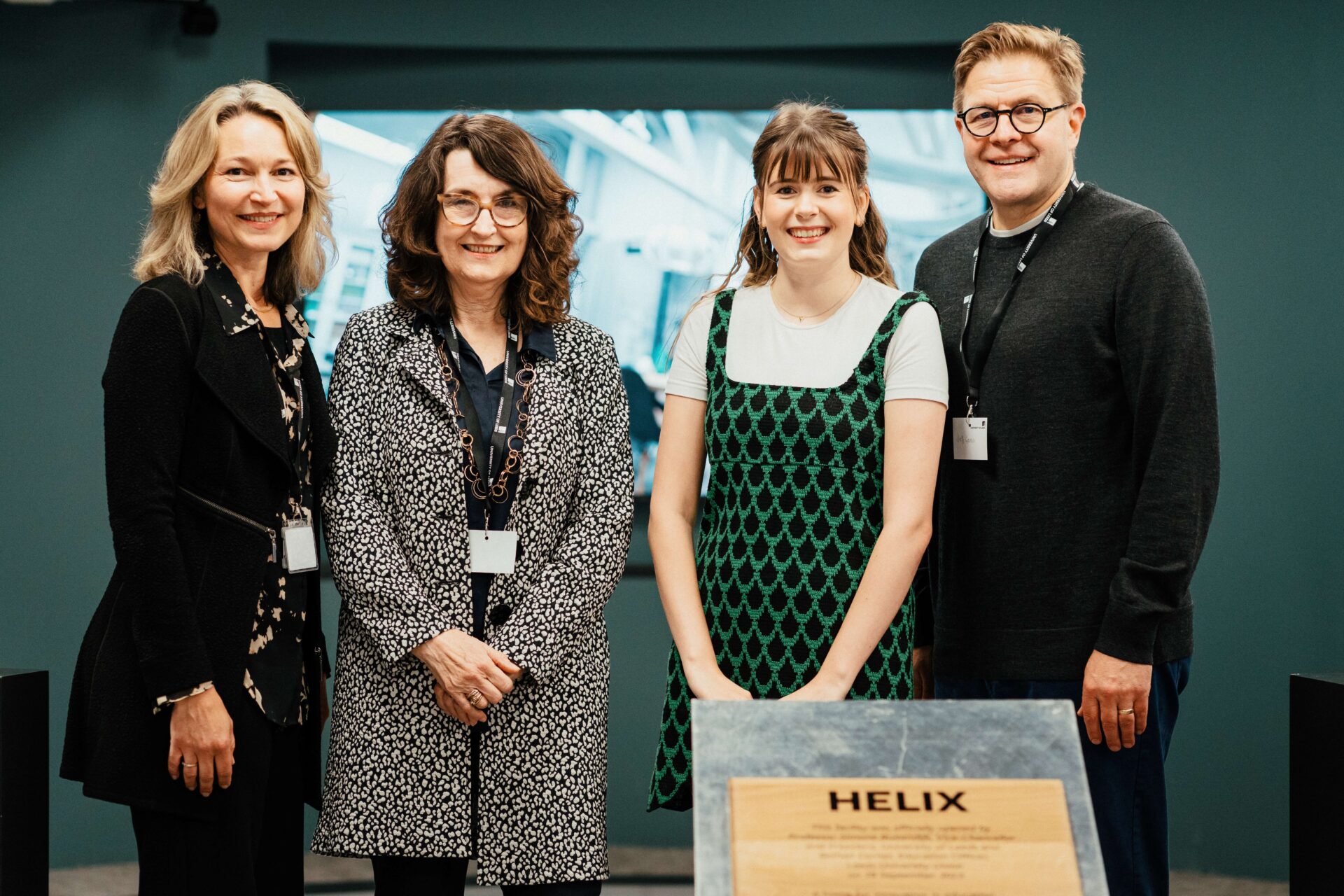 Margaret Korosec, Simone Buitendijk, Bethan Corner and Jeff Grabill pose by the OmniDeck with the HELIX opening plaque